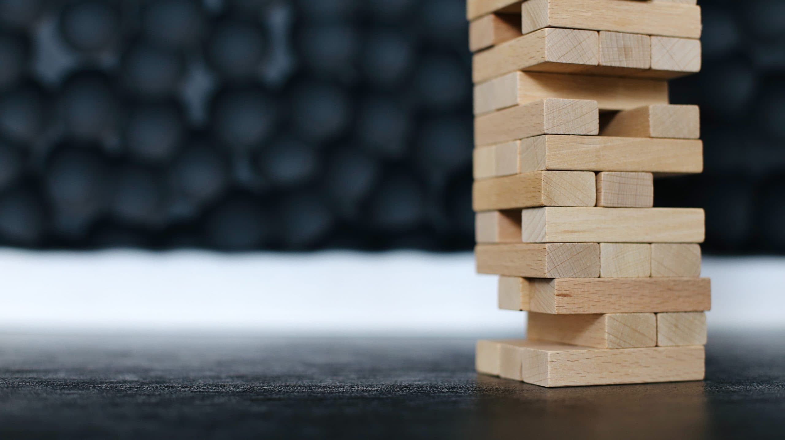 A wooden block stack on a black backdrop, perfect for showcasing on a church website or digital church platform.